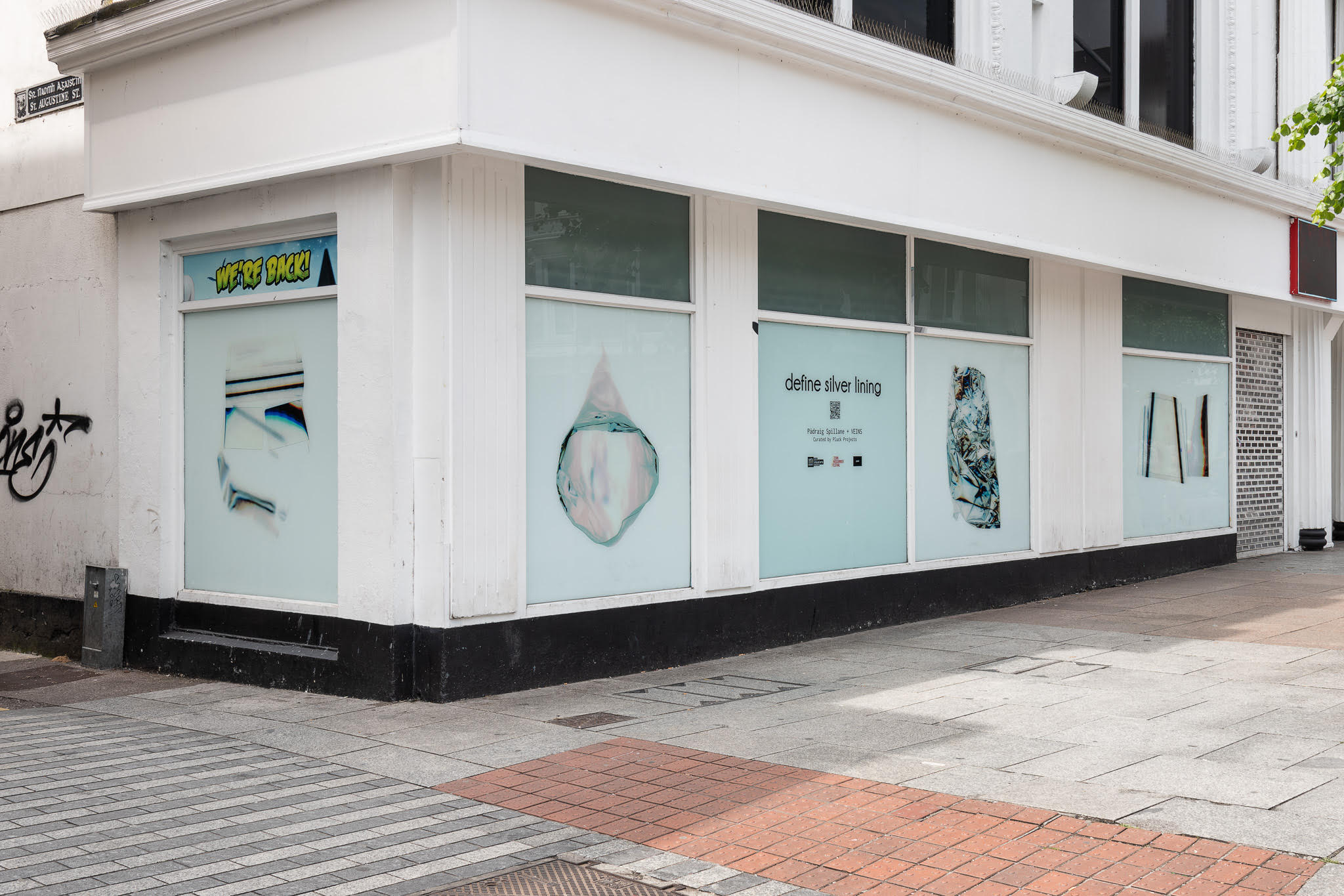 Photograph of the define silver lining installation displayed in shop windows